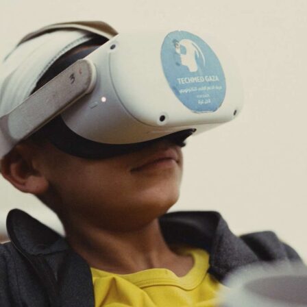 Small boy wearing VR headset in Gaza